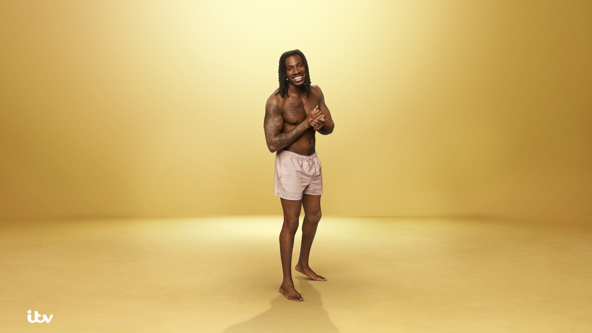 Shaq Muhammad poses in a swimsuit