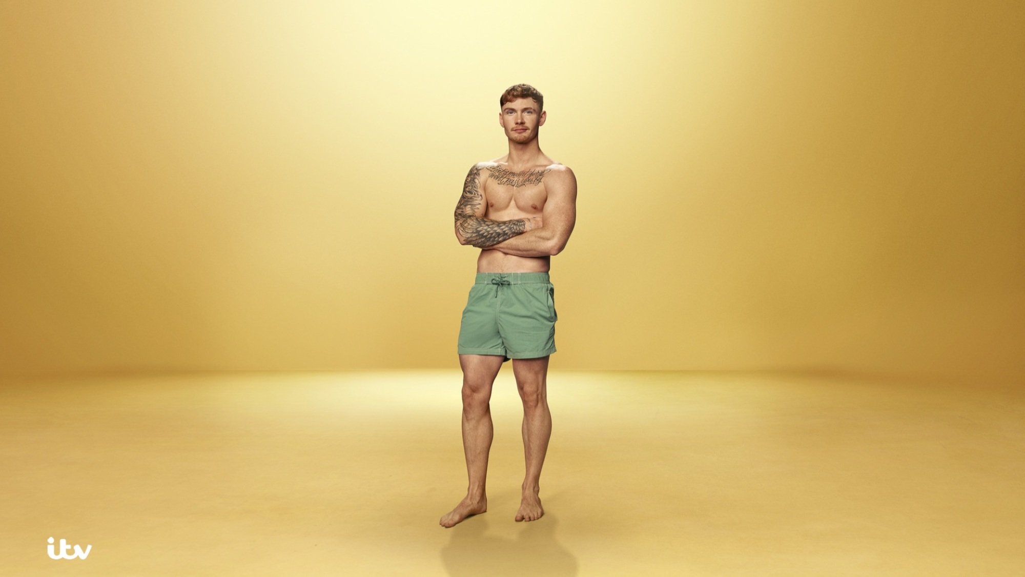 Jack Keating poses in a swimsuit.